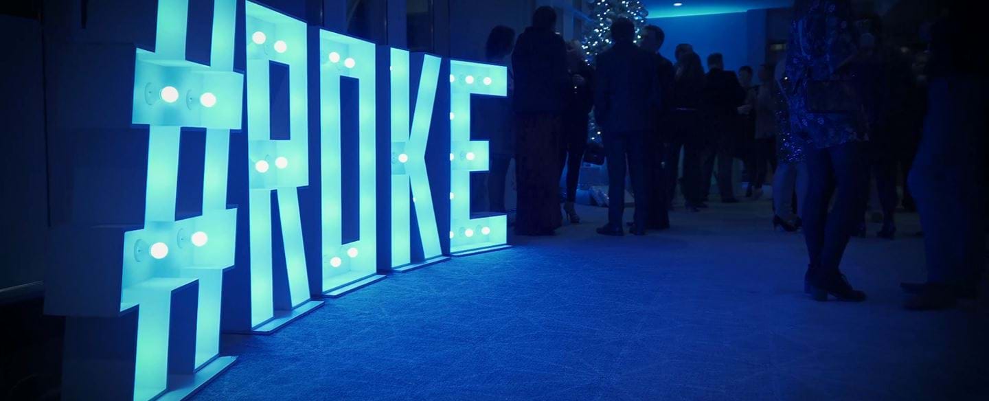 A light up Roke sign at the 2019 Christmas party