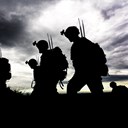 Soldiers with communications gear silhouetted 