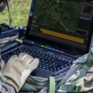 A soldier using the VIPER software on a ruggedised laptop