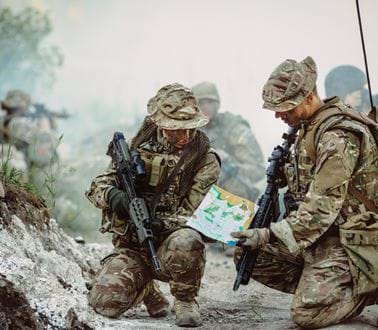 Two soldiers with guns and a map