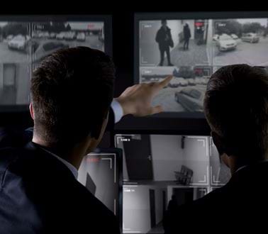 Police operatives observing a CCTV system