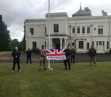Roke employees raising the flag for Armed Forces Day